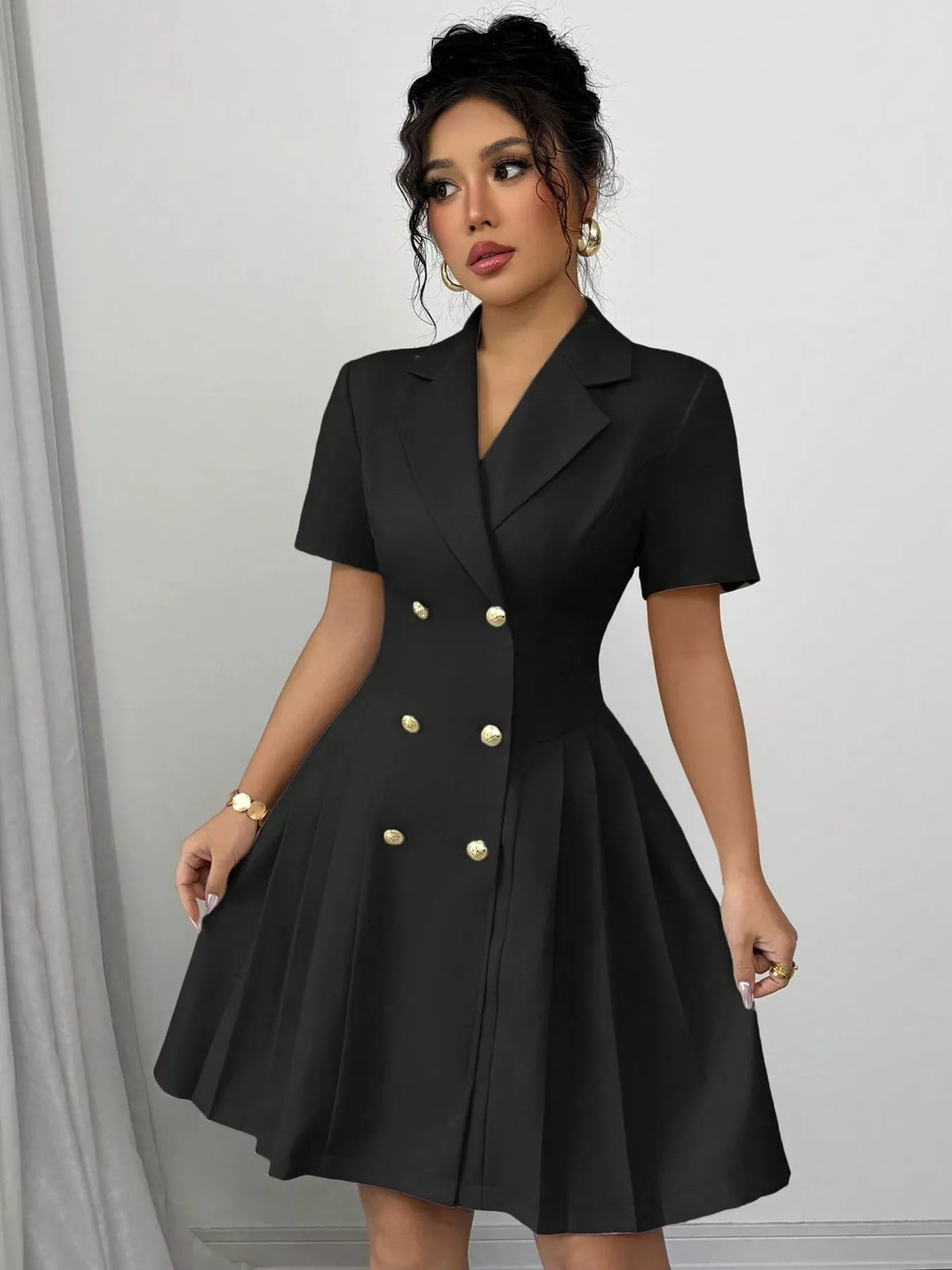 Black double-breasted pleated blazer mini dress, front view.