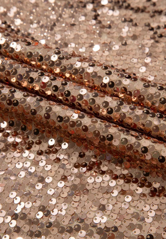 Gold-tone sequin dress fabric close-up