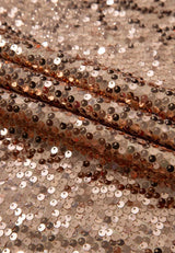 Gold-tone sequin dress fabric close-up