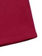 Red pearl-trim v-neck bodycon dress, hem detail.