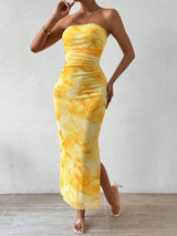 Yellow printed strapless side-slit maxi dress, front view.