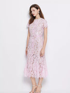 Pink short-sleeve lace mermaid midi dress, side view.