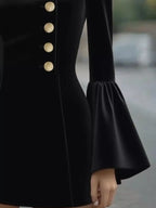 Black ruffled bell-sleeve mini dress, cuff detail.