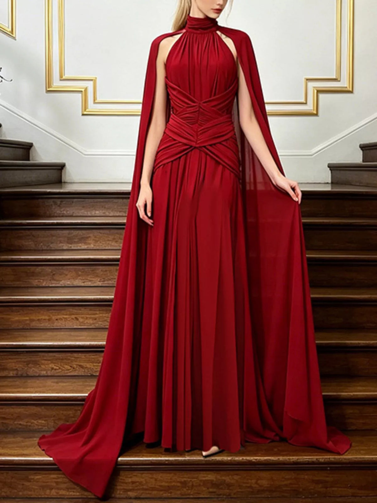 Red ruched halter cape maxi dress, front view.