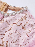 Pink short-sleeve lace mermaid midi dress, neckline detail.
