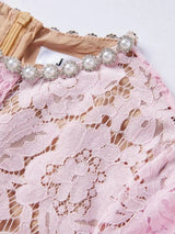 Pink short-sleeve lace mermaid midi dress, neckline detail.