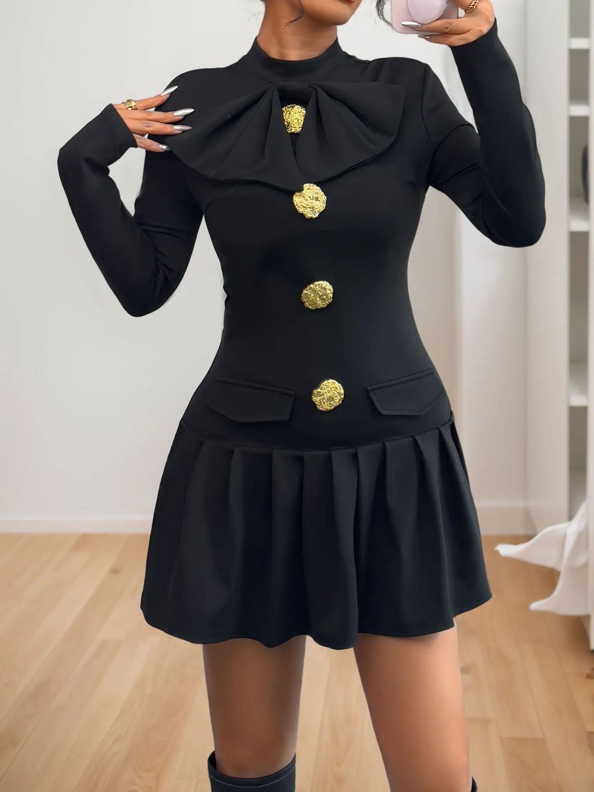 Black mock-neck long-sleeve mini dress, front view.