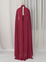 Burgundy ruched halter cape maxi dress, back view.