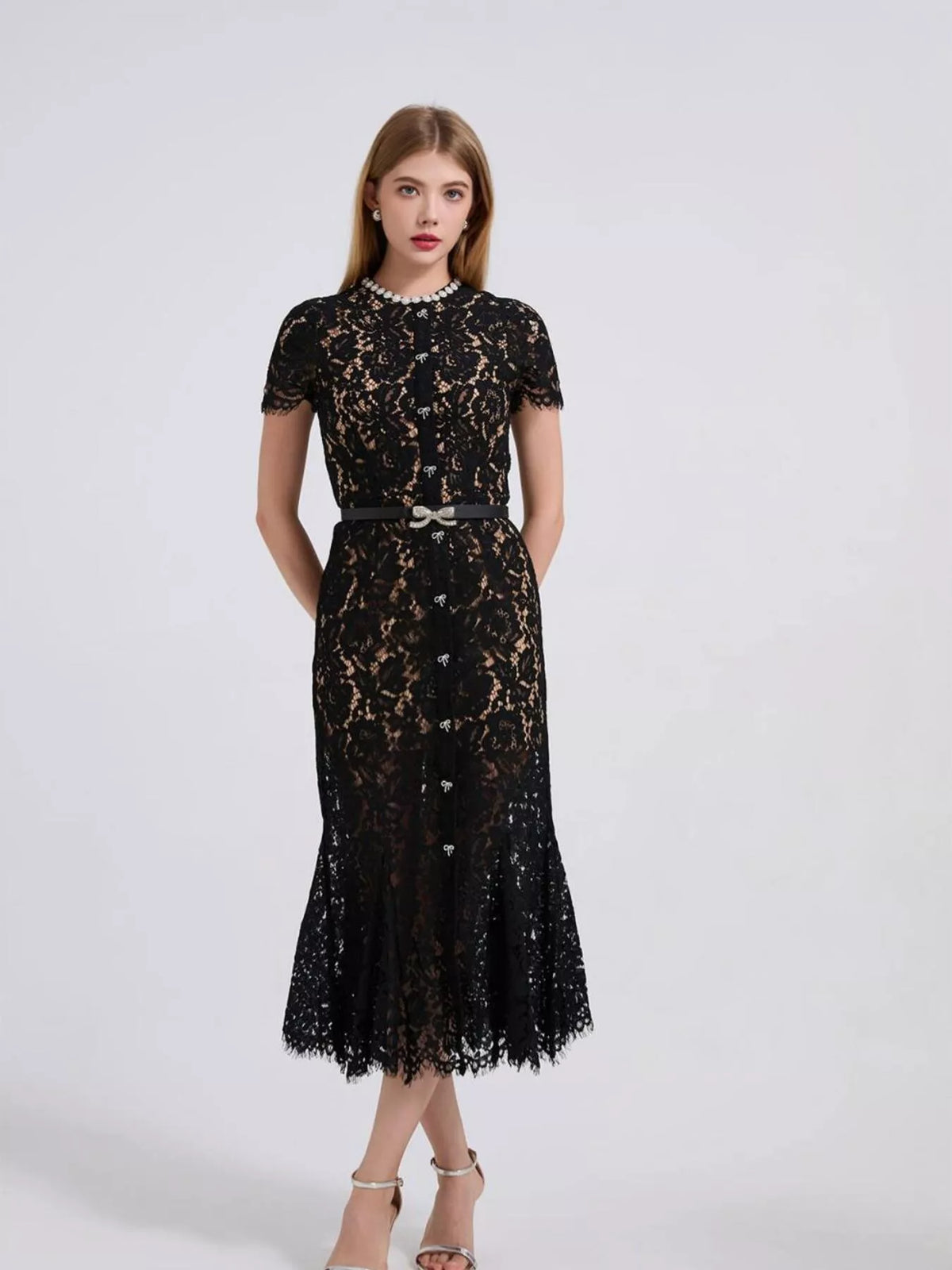 Black short-sleeve lace mermaid midi dress, side view.