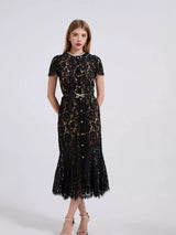 Black short-sleeve lace mermaid midi dress, side view.