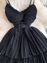 Black pleated layered spaghetti-strap midi dress, waist detail.