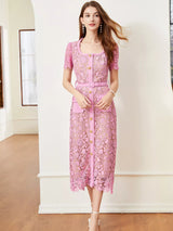 Pink lace button-up midi dress with pockets, front view.