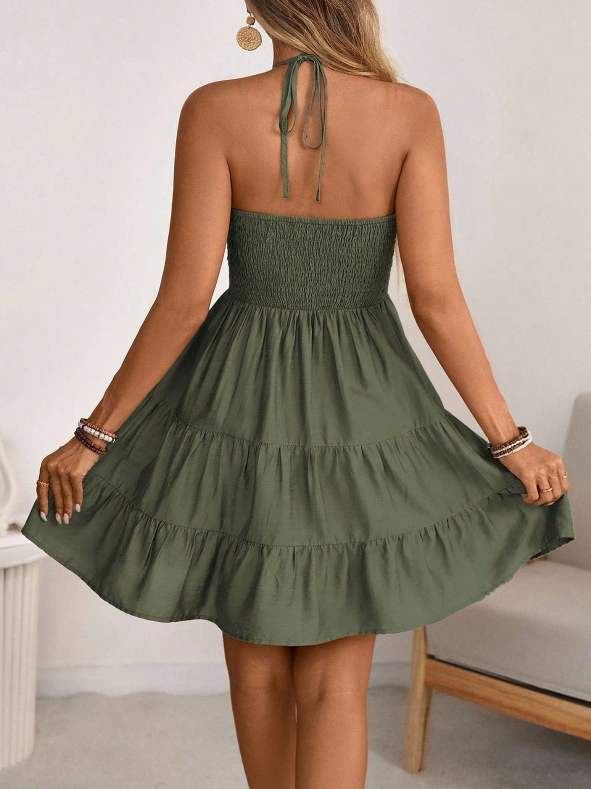 Olive green smocked halter tiered mini dress, back view