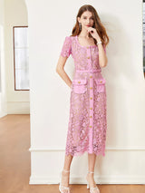 Pink lace button-up midi dress with pockets, front view.