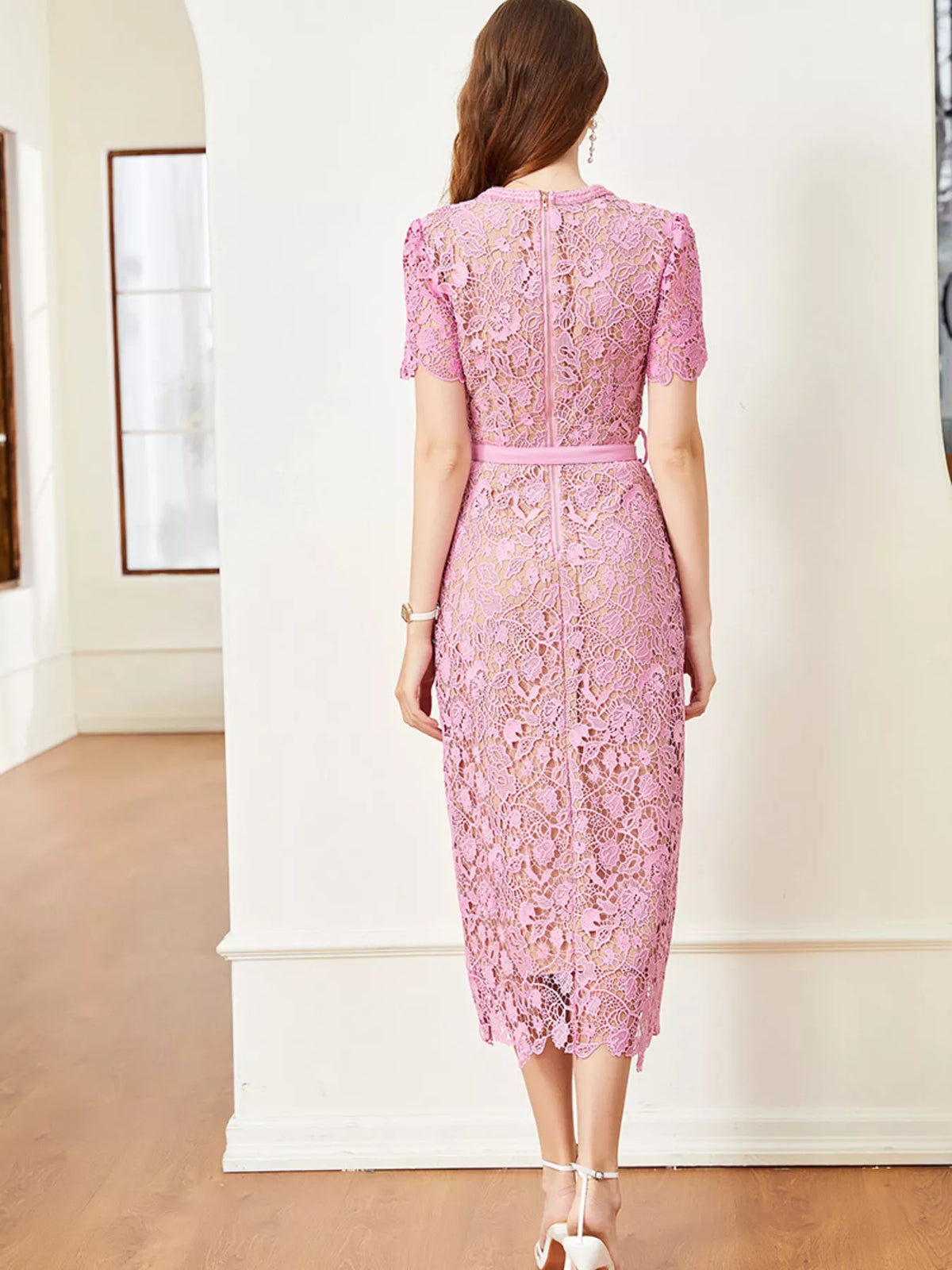 Pink lace button-up midi dress with pockets, back view.