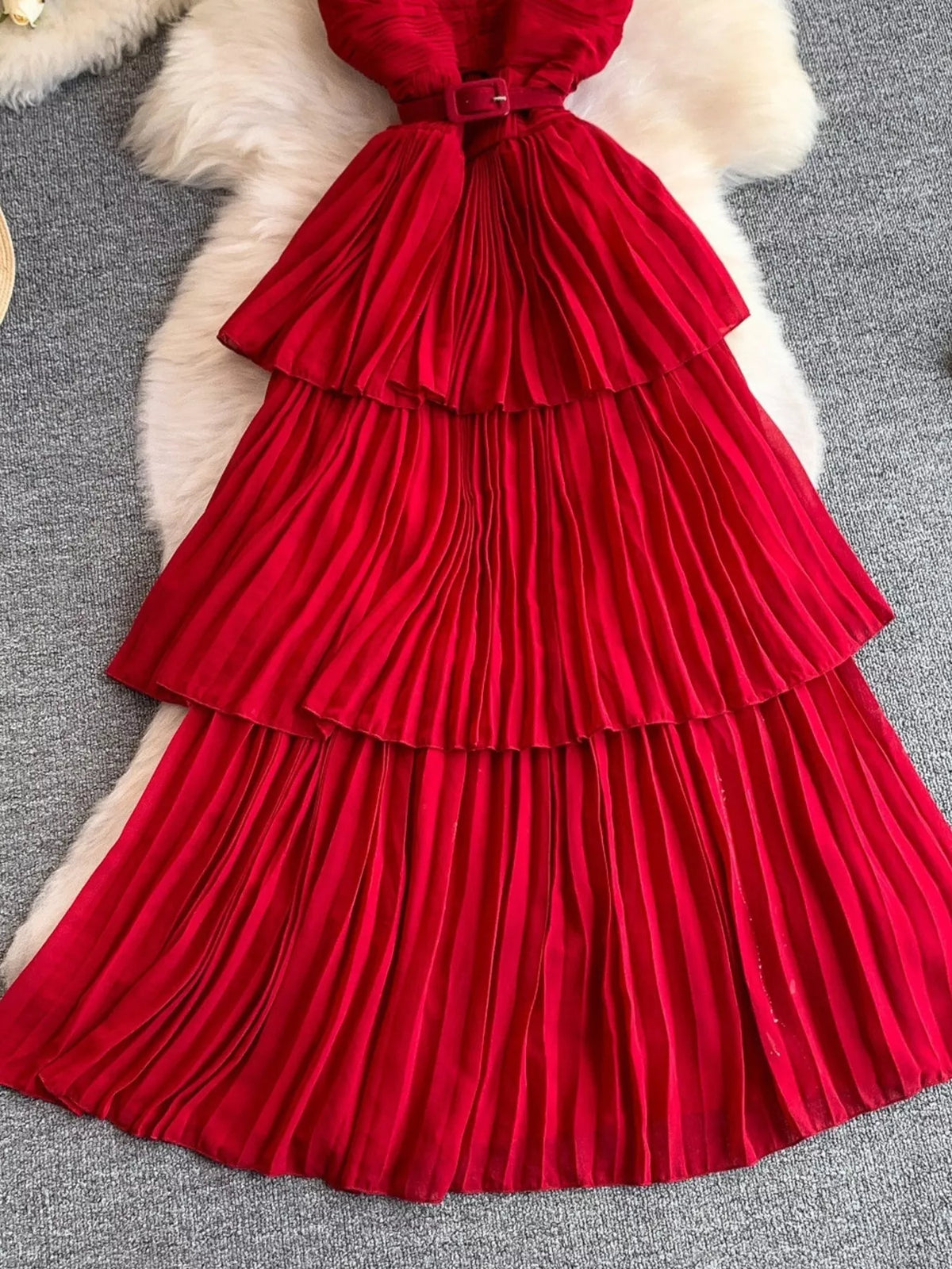 Red pleated layered spaghetti-strap midi dress, skirt detail.