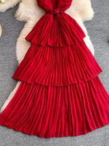 Red pleated layered spaghetti-strap midi dress, skirt detail.