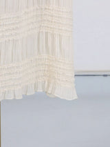 Ivory ruched halter neck maxi dress, hem detail.