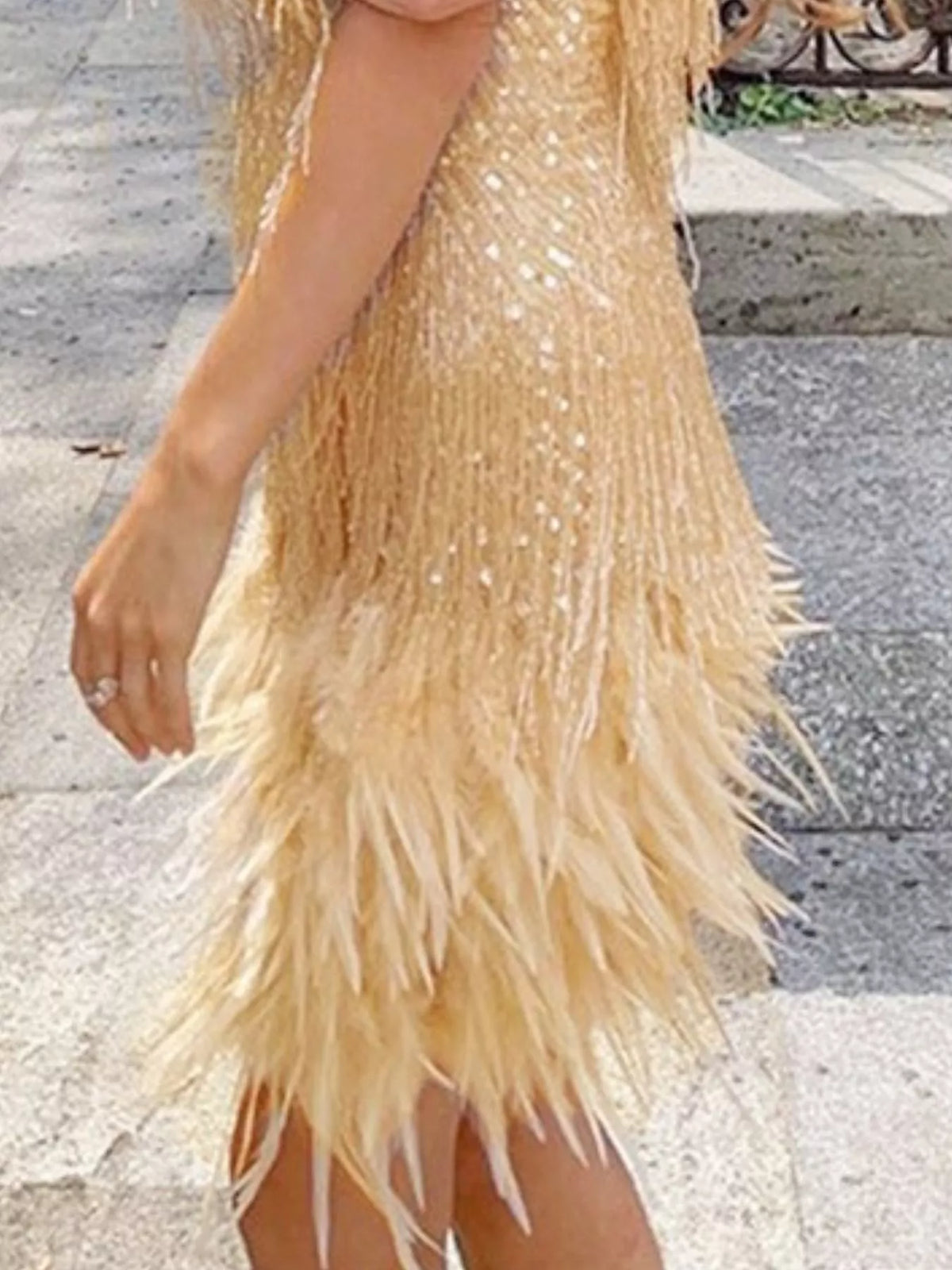 Gold plus-size sequin feather-fringe mini dress, side view.