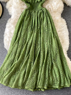 Green ruffled mock-neck lace maxi dress, skirt detail.