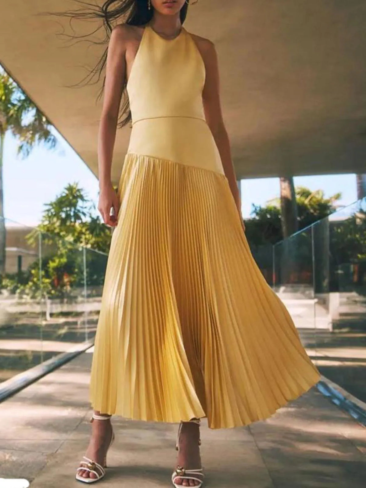 Yellow pleated halter-neck maxi dress, front view.