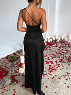 Black one-shoulder ruched satin dress with high slit, back view.