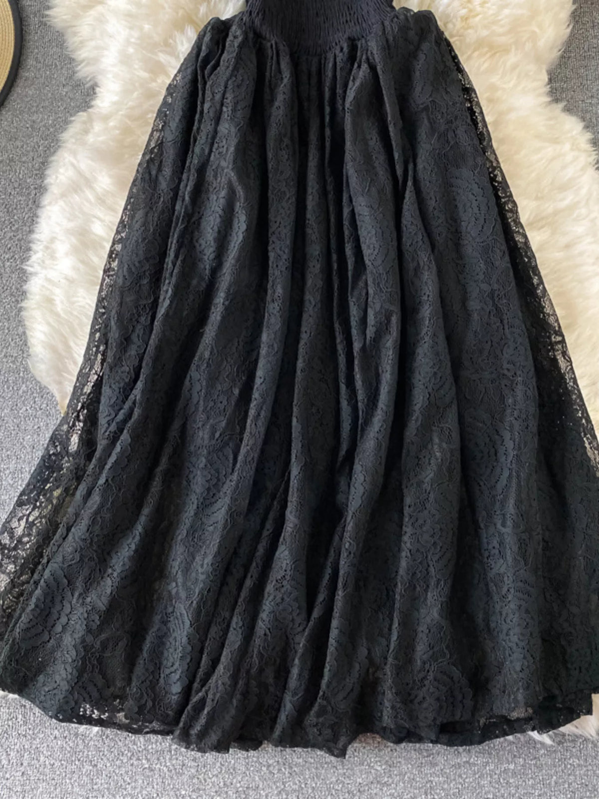 Black ruffled mock-neck lace maxi dress, skirt detail.