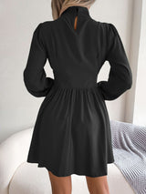 Black long-sleeve cutout-neck mini dress, back view