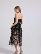 Black floral appliqué strapless midi dress, side view.