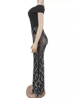 Black rhinestone sheer off-shoulder maxi dress, side view.