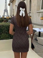 Black polka dot polka dot cutout tie-front mini dress, back view.