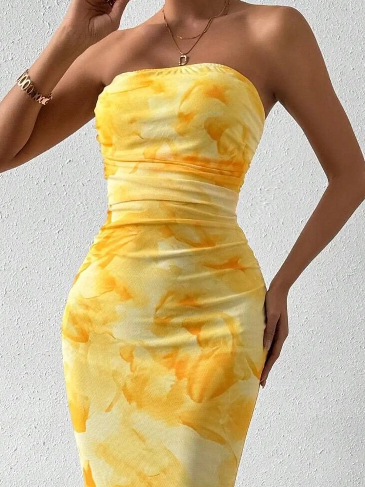 Yellow printed strapless side-slit maxi dress, neckline detail.