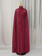 Burgundy ruched halter cape maxi dress, front view.