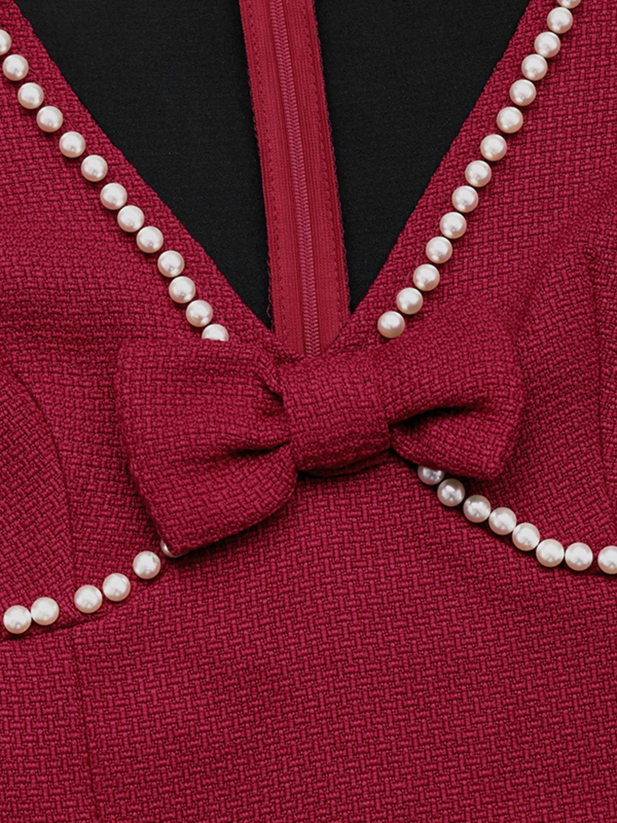 Red pearl-trim v-neck bodycon dress, neckline detail.
