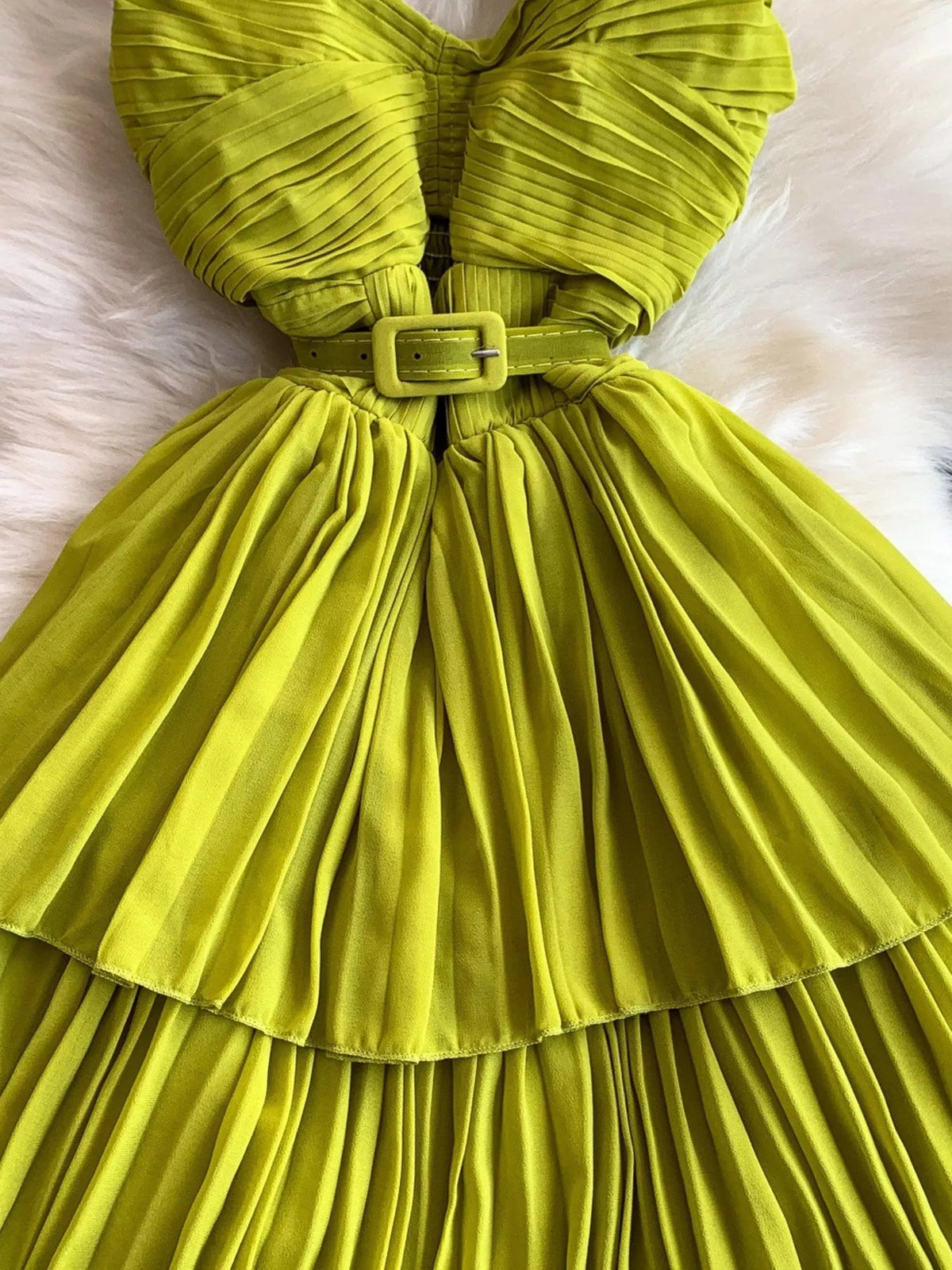Lime green pleated layered spaghetti-strap midi dress, waist detail.