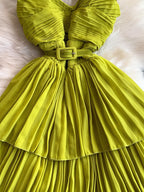 Lime green pleated layered spaghetti-strap midi dress, waist detail.