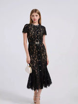 Black short-sleeve lace mermaid midi dress, front view.