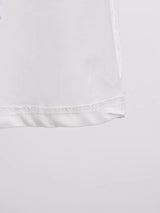 White sleeveless floral appliqué midi dress, hem detail.