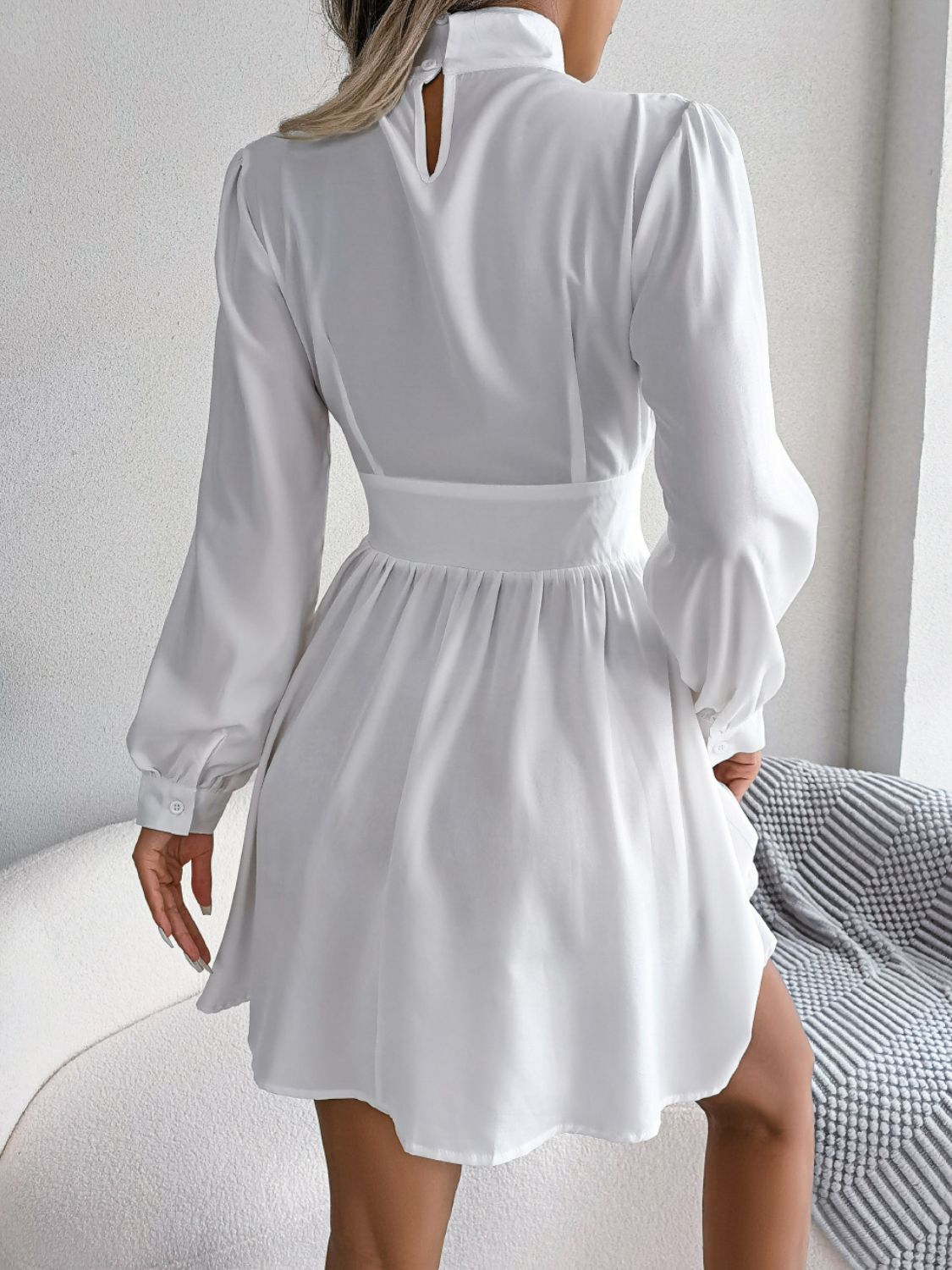 White long-sleeve cutout-neck mini dress, front view