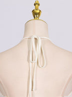 Ivory ruched halter neck maxi dress, back neckline detail.