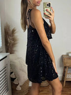 Black plus-size sequin tie-shoulder mini dress, side view.