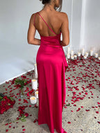 Red one-shoulder ruched satin dress with high slit, back view.